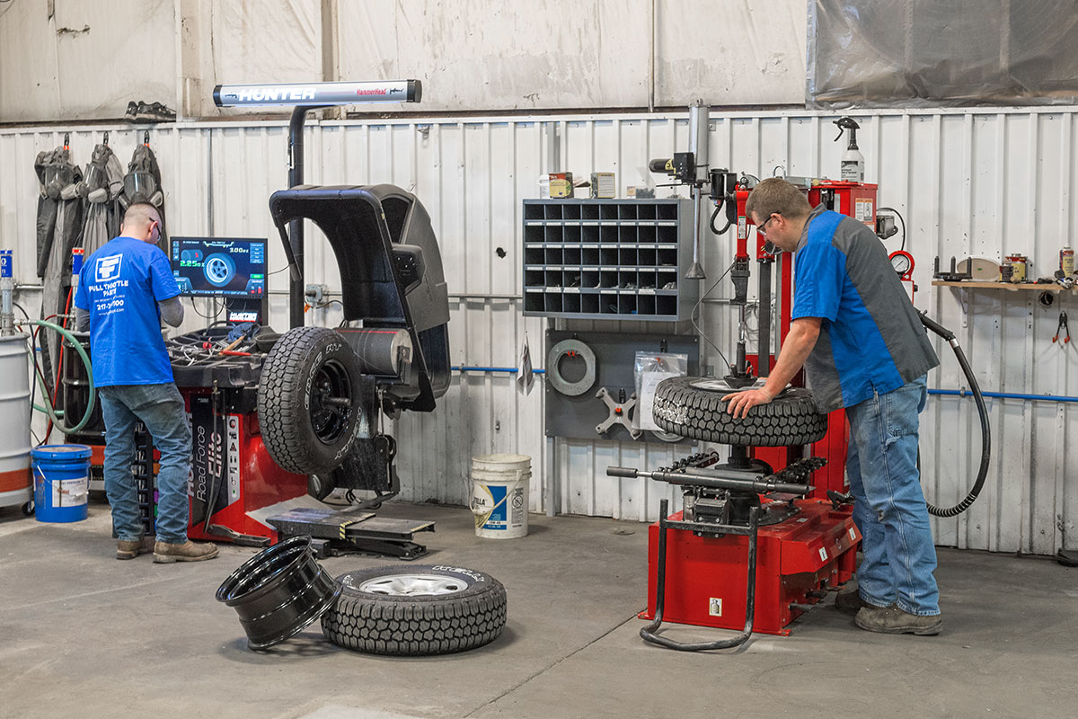 technicians using hunter wheel balancer and tire changer together