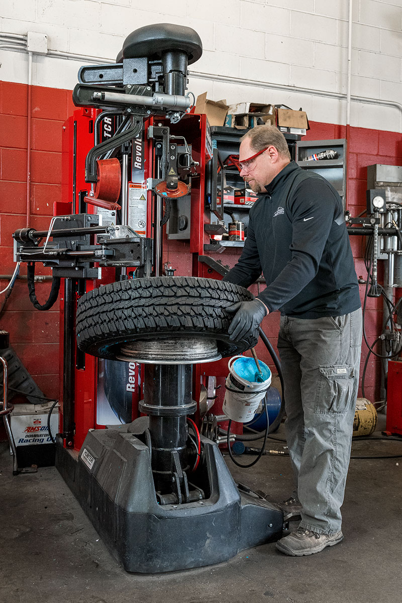 technician mounting tire on revolution